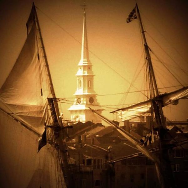 A church steeple as seen through a shipyard