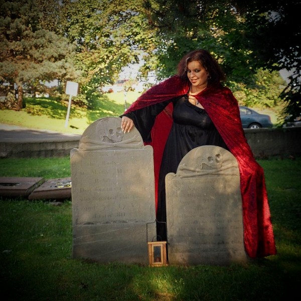 Roxy sitting atop a tombstone