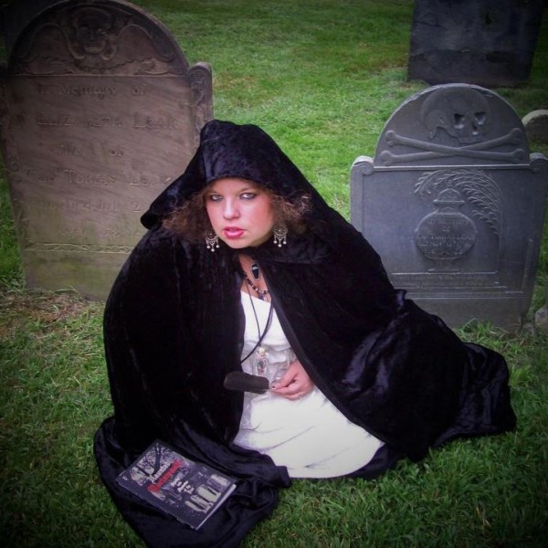 Roxy posing in front of two tombstones
