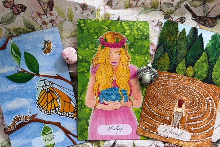Three illustrated cards depicting nature and transformation themes, with a butterfly and a woman holding a jar.